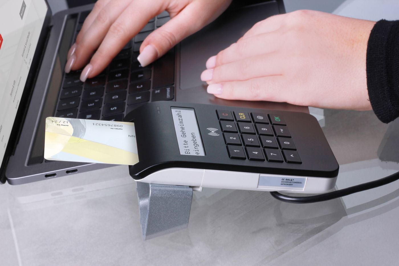 Card payment being made at a laptop